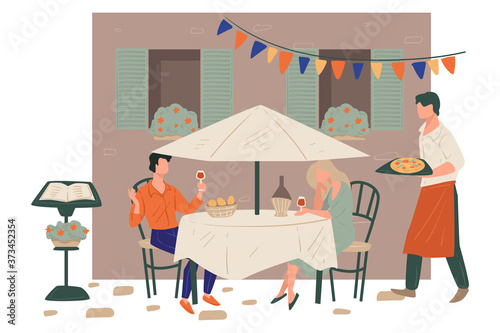 Couple drinking wine served by waiter with pizza