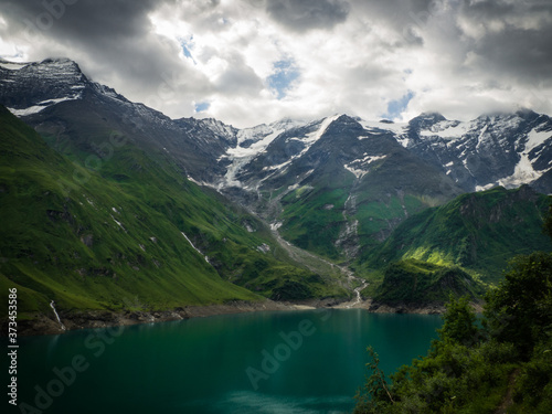Scenic view on Wasserfallboden See near Kaprun, Austria, Europe. National park Hohe Tauern. Charming lake with amazing deep colorful water and wild clouds on sky.