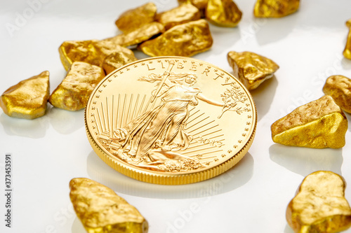 golden american eagle one ounce coin laying on a heap of golden nuggets, golden ore