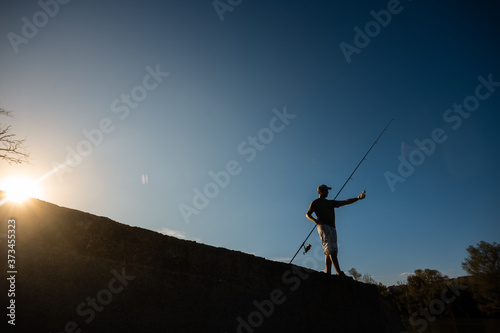 river fisherman with fishing rod © robcartorres