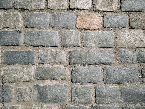 Texture of gray paving stones, top view.