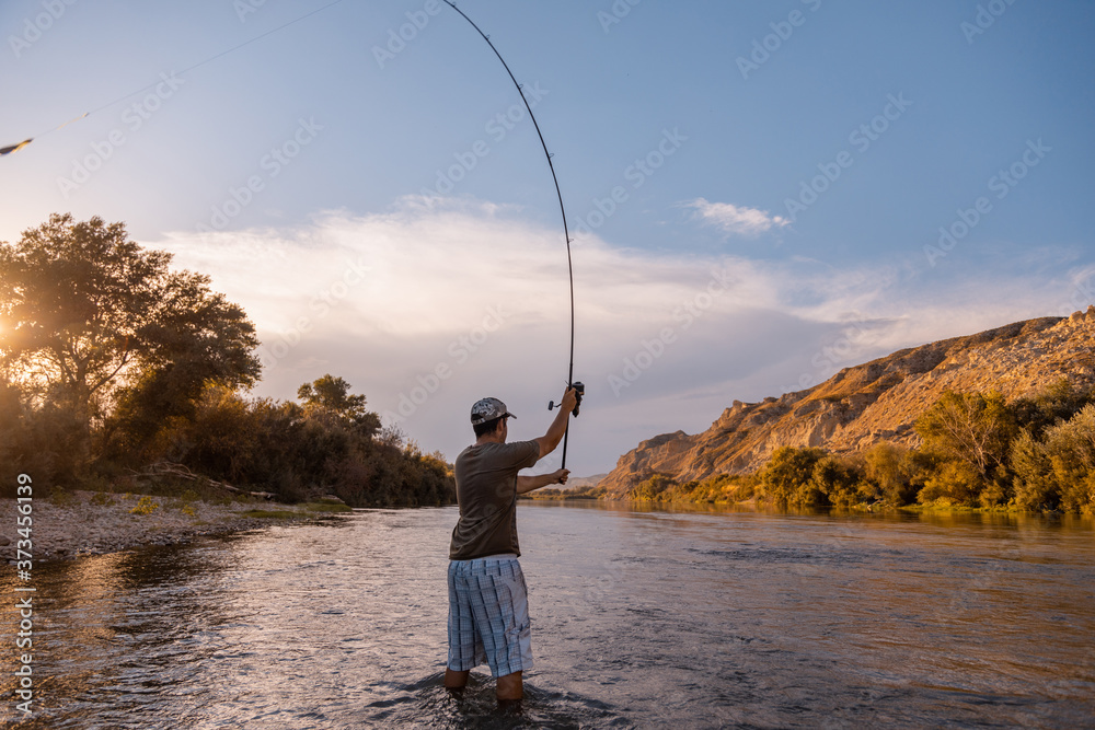 river fisherman with fishing rod river fisherman with fishing rod