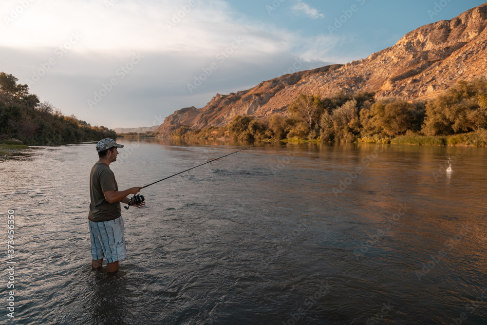 river fisherman with fishing rod