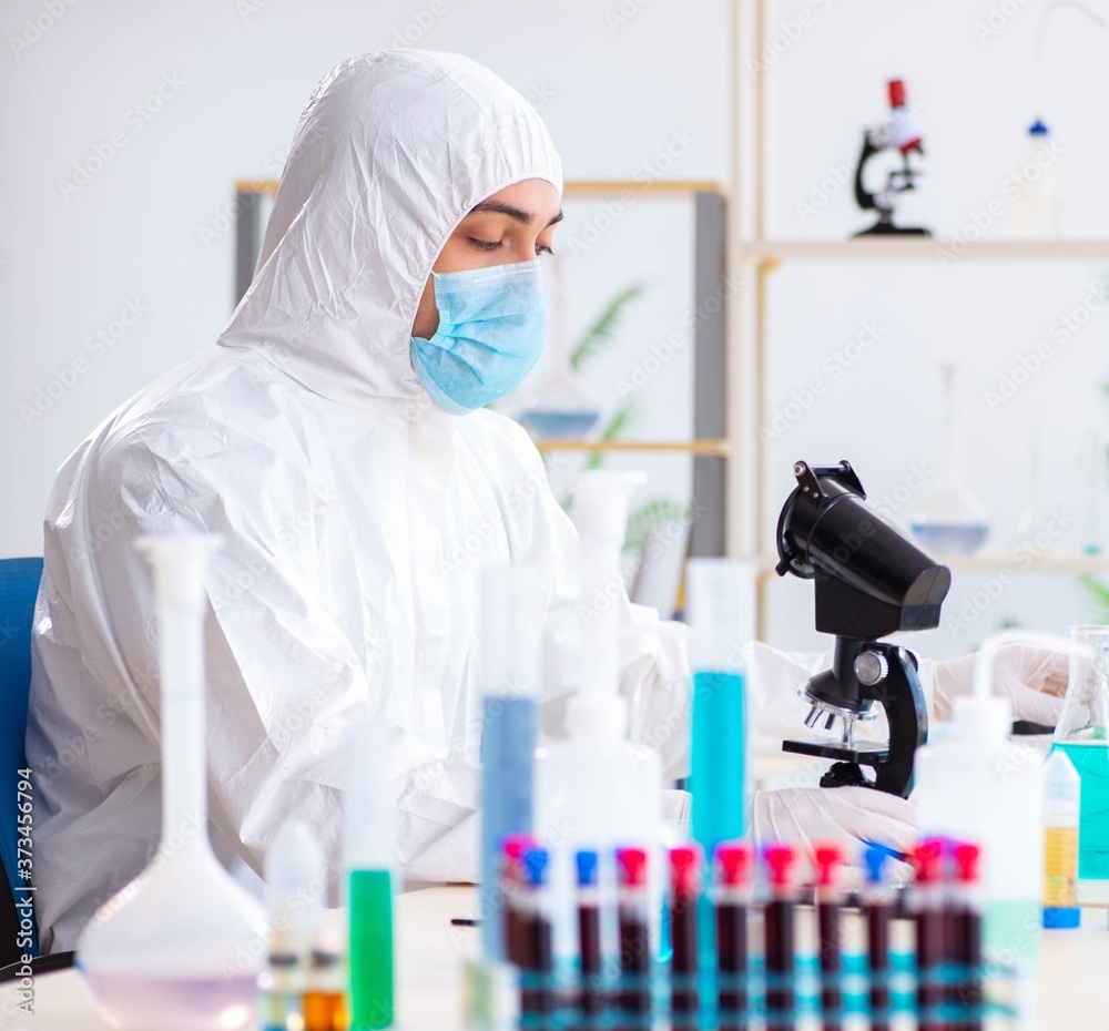 Young chemist student working in lab on chemicals Young chemist student working in lab on chemicals