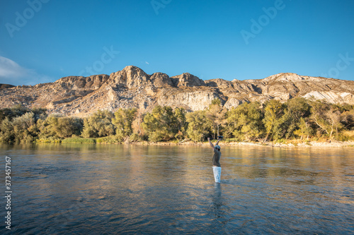 river fisherman with fishing rod