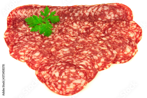 Group of thin slices of french dry salami and parsley isolated on white background