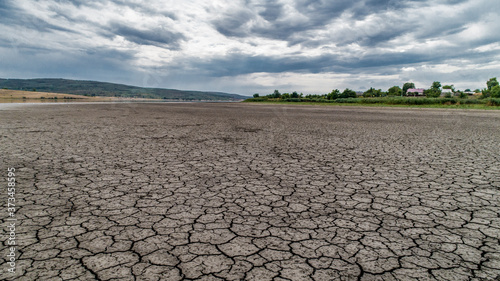 Dry soil of the lake with clouds on sky