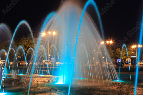 The scenic view of picturesque fountain with colorful illumination at night, Ukraine Dnepropetrovsk city, Dnipro . Creative water design