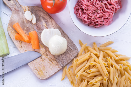 Pasta, minced meat, onion and other vegetables to cook Italian bolognesa. Healthy cuisine. Top view.