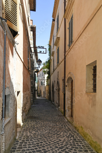 Fototapeta Naklejka Na Ścianę i Meble -  A small street between the old houses of Giuliano di Roma, of a medieval village in the Lazio region, Italy.