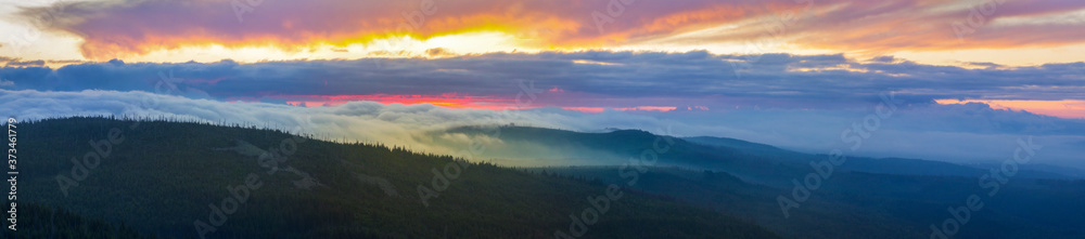 Calm view to the Steinfleckberg mountain in morning clouds, from the Lusen summit, in the Bavarian Forest, South Germany