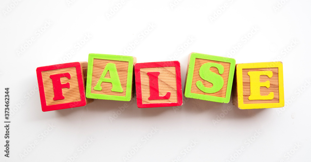False word made from colourful wooden baby development blocks False word made from colourful wooden baby development blocks