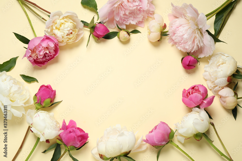 Frame made of beautiful peonies on beige background, flat lay. Space for text