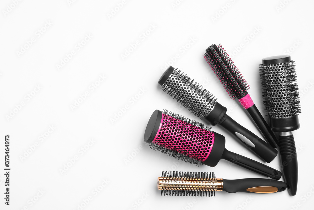 Composition with round hair brushes on white background, top view Composition with round hair brushes on white background, top view