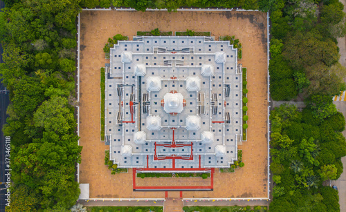 Aerial view of white pagoda or stupa of Asok Maharat buddhist Temple at sunset, Samut Prakan Province, Thailand. Thai architecture. Tourist attraction landmark. photo