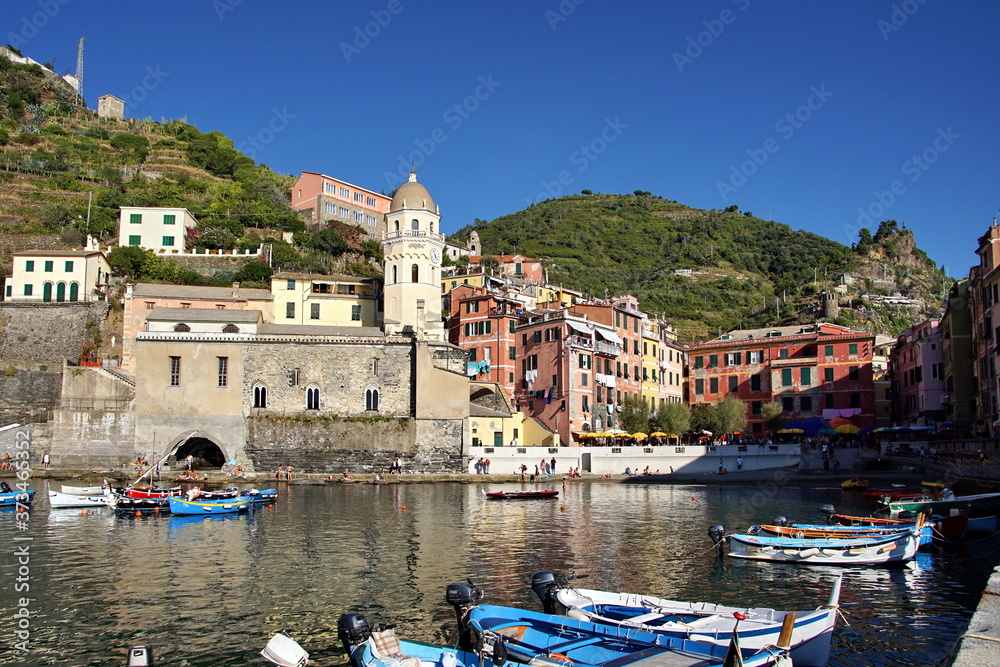 View on bay of water with moored boats and typical colorful houses