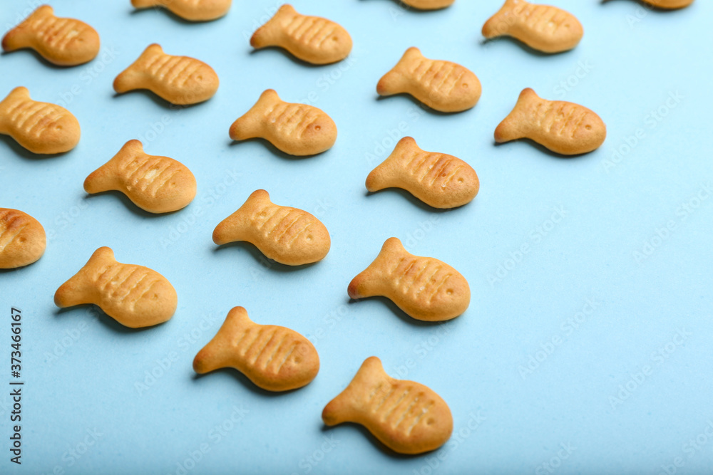 Delicious goldfish crackers on light blue background, closeup Delicious goldfish crackers on light blue background, closeup