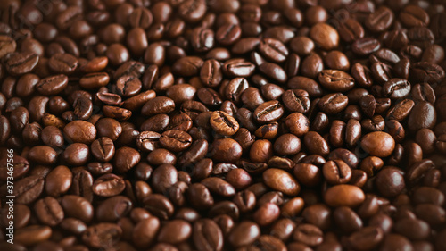 The background shows a lot of roasted natural aromatic coffee beans  which will make a strong invigorating espresso.