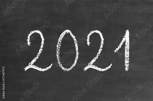 2021 numbers in handwritten thin stroke white chalk brush font, stock vector illustration clip art design element on grunge black chalkboard background for calendar, poster, flyer, card