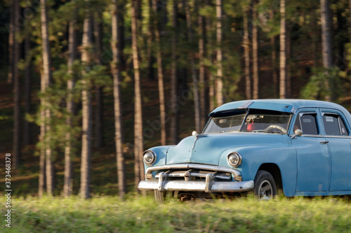 Blue classic car in the forest of cuba © Eleazar