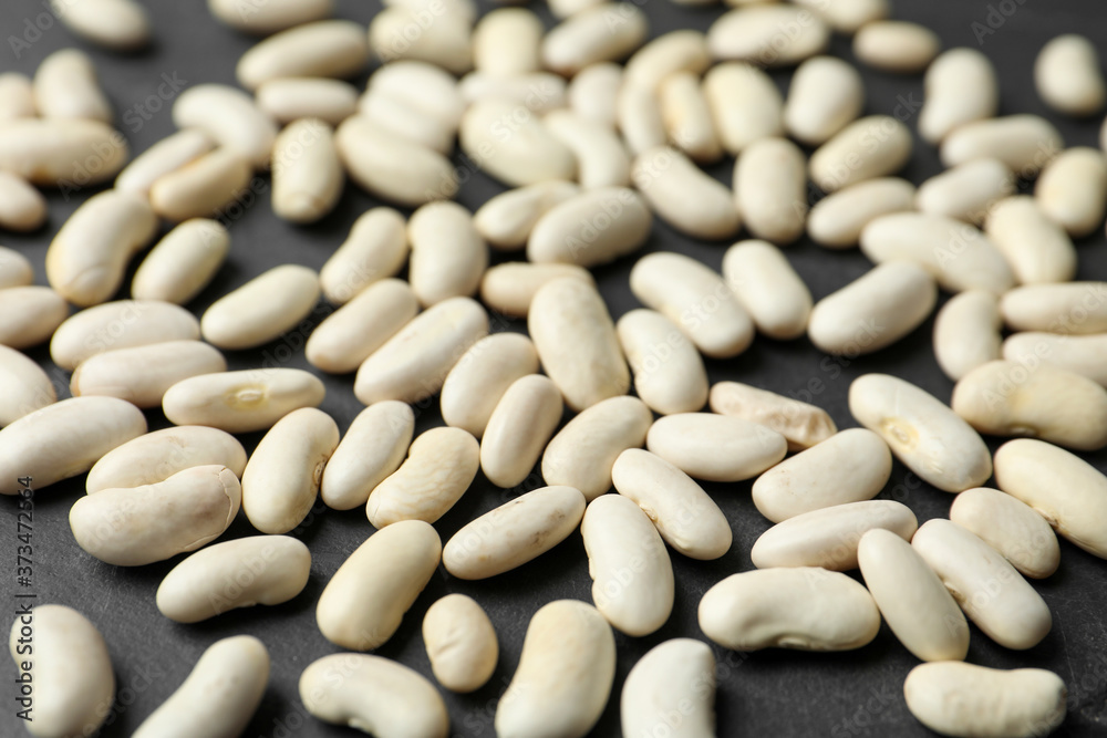 Raw beans on black background, closeup. Vegetable seeds