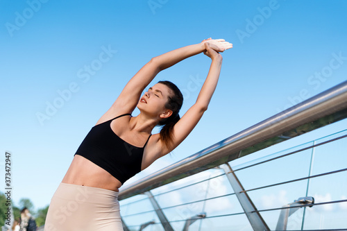 Young athletic woman making sport training outdoors alone