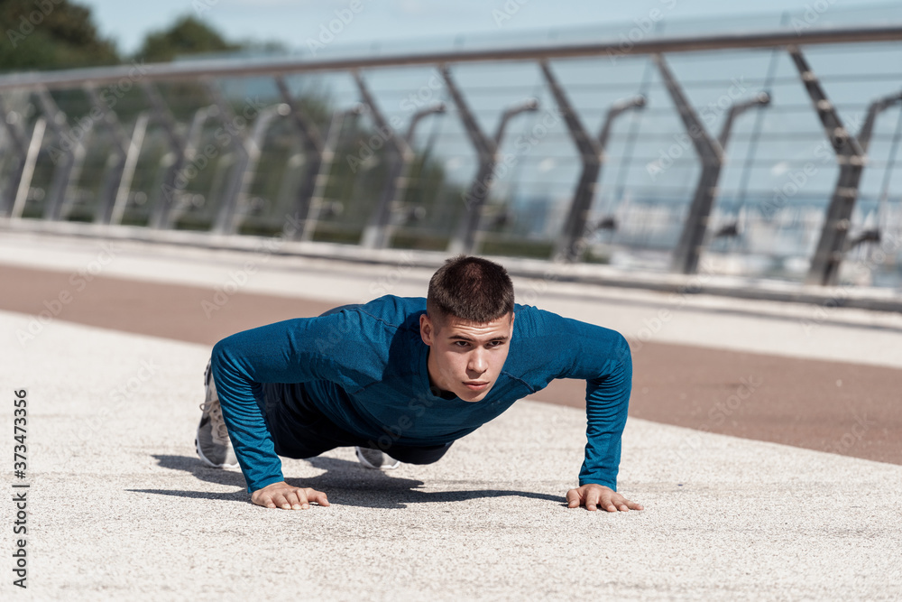 Fototapeta premium Young sportsman making sport training outdoors alone