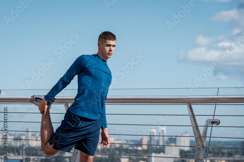 Young adult man making sport training outdoors alone