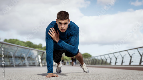 Fototapeta Naklejka Na Ścianę i Meble -  Young athletic man making sport training outdoors alone