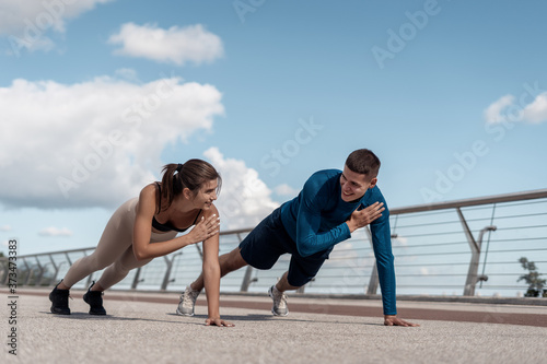 Man and woman making sport training outdoors together