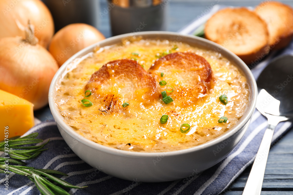 Tasty homemade french onion soup served on table, closeup Tasty homemade french onion soup served on table, closeup