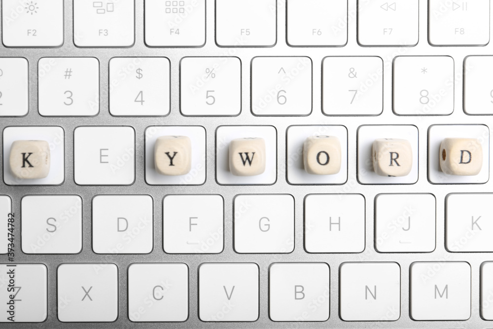 Beads with word KEYWORD on keyboard, flat lay Beads with word KEYWORD on keyboard, flat lay
