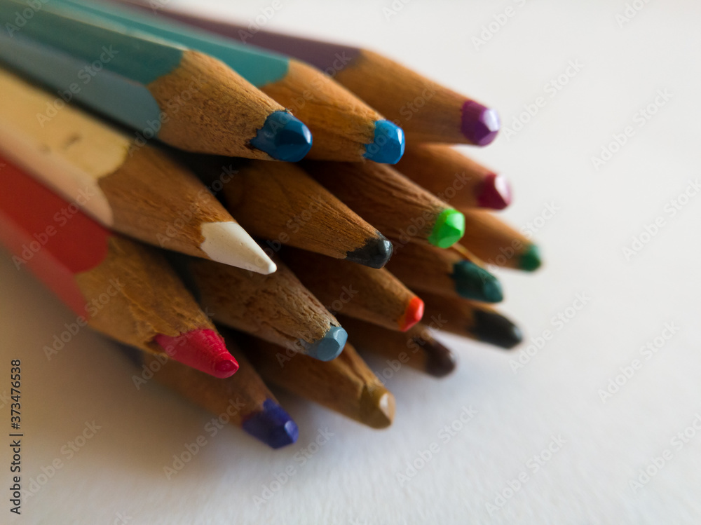 Old used wood crayons tops grouped in stack isolated on white background, school equipment for drawing Old used wood crayons tops grouped in stack isolated on white background, school equipment for drawing