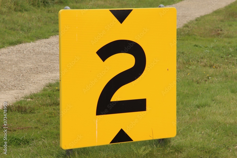 Yellow sign at rowing facility in Zeven huizen with the number 2 Yellow sign at rowing facility in Zeven huizen with the number 2
