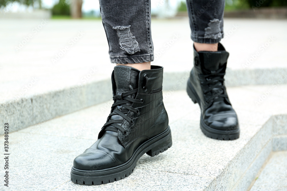 Woman wearing comfortable stylish boots outdoors, closeup Woman wearing comfortable stylish boots outdoors, closeup