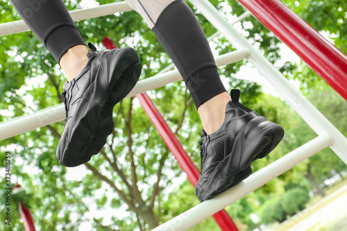 Woman in comfortable stylish shoes training outdoors, closeup