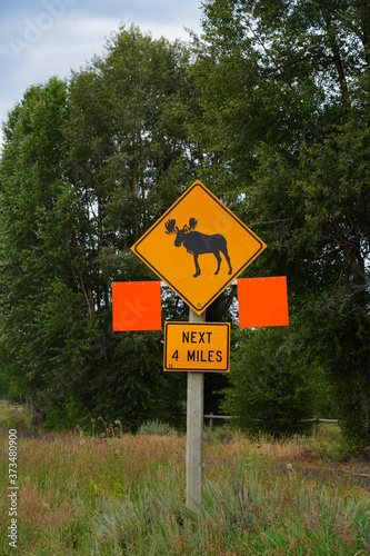 View of a moose crossing sign on the road in Grand Teton National Park in Wyoming, United States