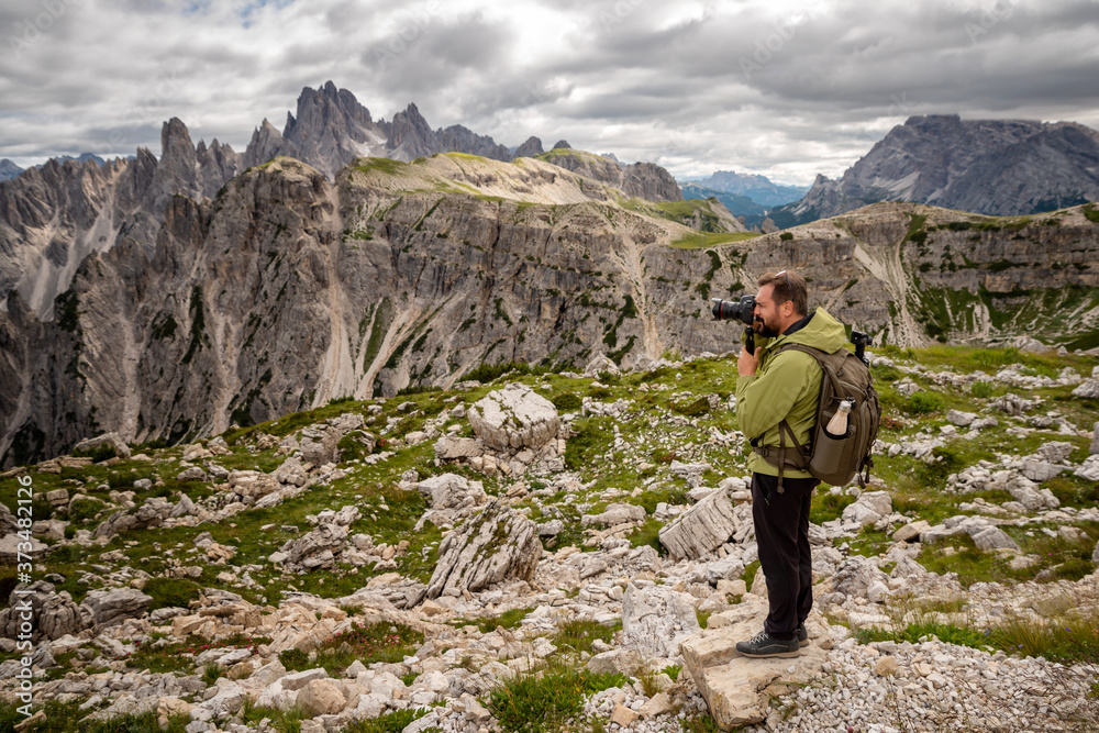 Photographer takes pictures of the mountain landscape.