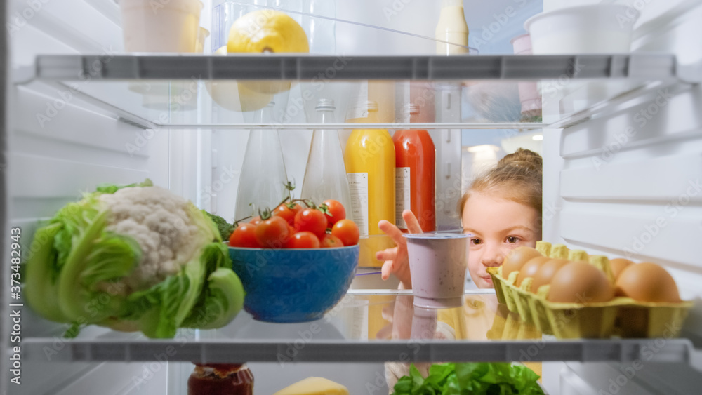Cute Little Girl Opens Fridge Door, Looks inside Takes out Healthy Yogurt. Smart Little Child Eats Healthy. Shot from Inside the Fridge. Point of View POV Shot from Refrigerator full of Good Food Cute Little Girl Opens Fridge Door, Looks inside Takes out Healthy Yogurt. Smart Little Child Eats Healthy. Shot from Inside the Fridge. Point of View POV Shot from Refrigerator full of Good Food