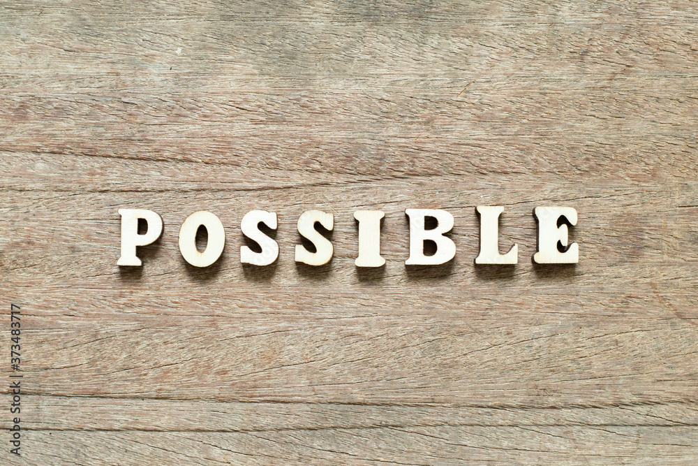 Fototapeta premium Alphabet letter block in word possible on wood background