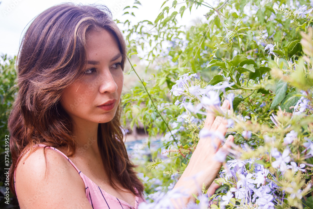 Young woman watching wildflowers. Young woman watching wildflowers.