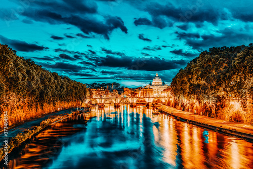 View on Bridge Vittorio Emanuele II (Ponte Vittorio Emanuele II) and Vatican city St. Peter's Basilica (Basilica di San Pietro) at night time. Rome. Italy. photo