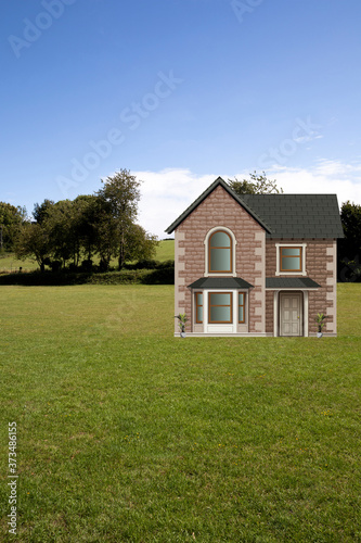 Picturesque rural scene with detached residential house and garden