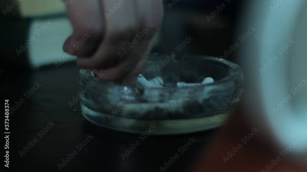 hand extinguishes the cigarette hand extinguishes the cigarette