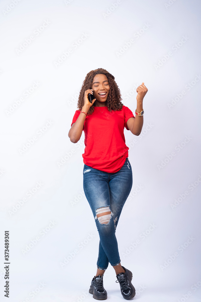 young black lady making a phone call, feeling excited young black lady making a phone call, feeling excited