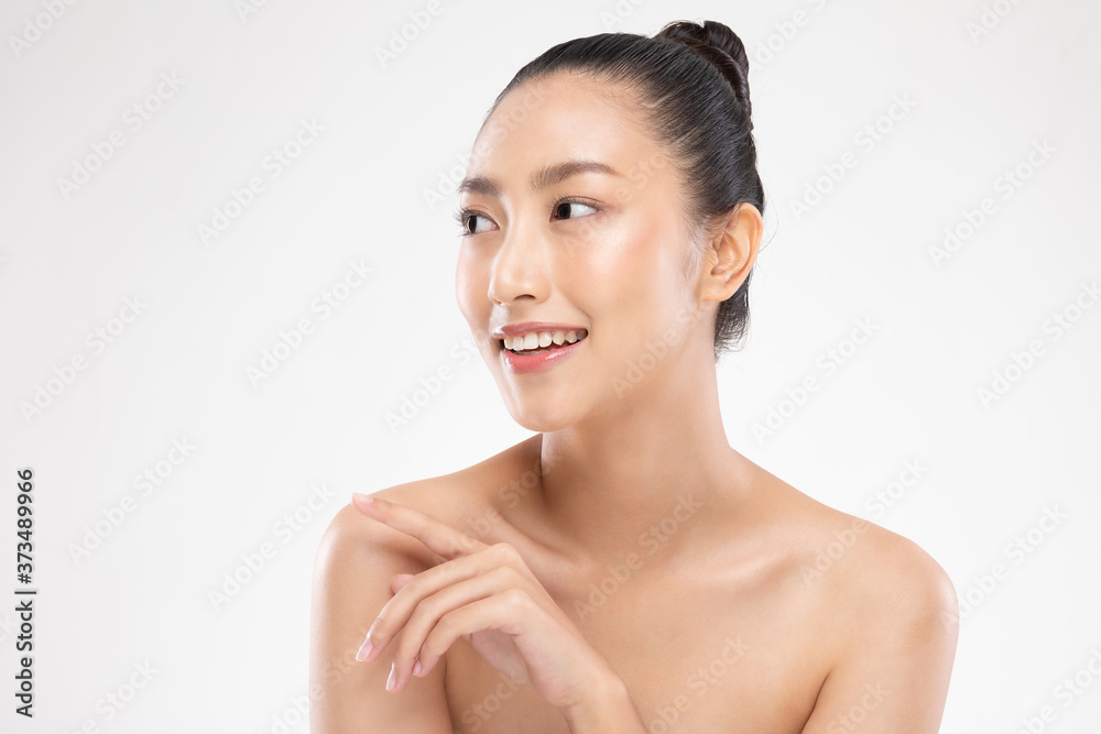 Beautiful Young Asian Woman Looking While Touching Shoulder feeling so happy and cheerful with healthy Clean and Fresh skin,isolated on white background,Beauty Cosmetics Concept