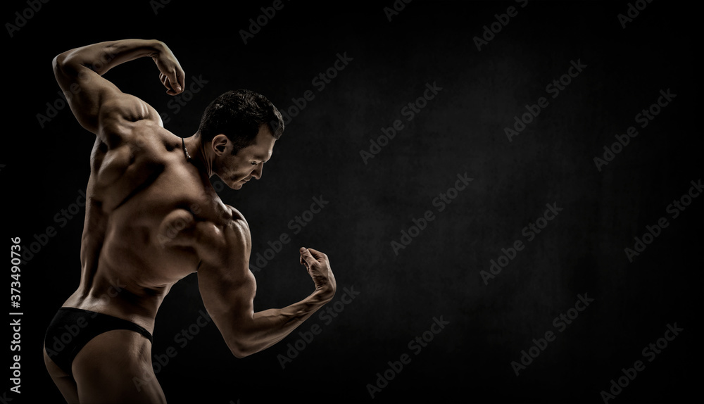 Obraz premium man - bodybuilder pose on black background