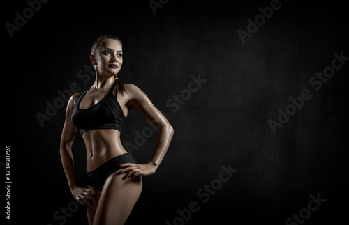 beautiful fitness woman on black background