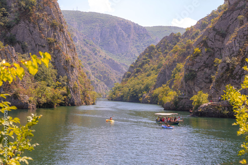 Boat in the river, mountains and rocks. View of Canyon Matka in Macedonia