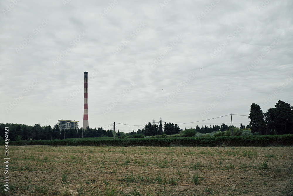 landscape with red and white industrial tower landscape with red and white industrial tower
